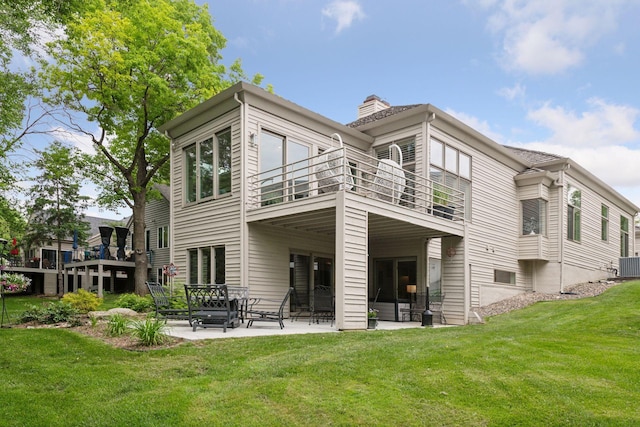 3490 Fairway Ln, Minnetonka, MN 55305 - rear view of property with a balcony, a yard, a patio area, a chimney, and central air condition unit