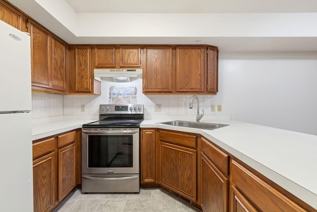 4805 Barbara Ln, Inver Grove Heights, MN 55077 - kitchen with stainless steel range with electric stovetop, under cabinet range hood, freestanding refrigerator, a sink, and backsplash
