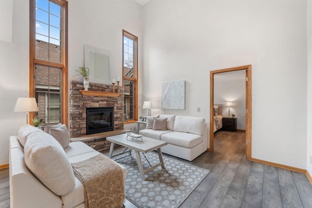 18504 Peach Tree Ct, Minnetonka, MN 55345 - living room with a towering ceiling, a stone fireplace, wood finished floors, and baseboards