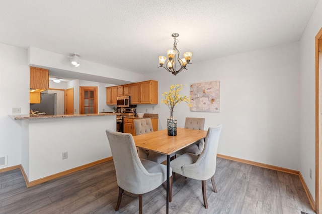 18504 Peach Tree Ct, Minnetonka, MN 55345 - dining room featuring a chandelier, baseboards, and wood finished floors