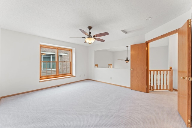 18504 Peach Tree Ct, Minnetonka, MN 55345 - carpeted empty room featuring ceiling fan, baseboards, attic access, and a textured ceiling
