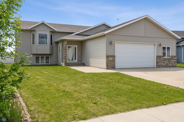 1878 10th St W, West Fargo, ND 58078 - tri-level home with concrete driveway, an attached garage, brick siding, and a shingled roof