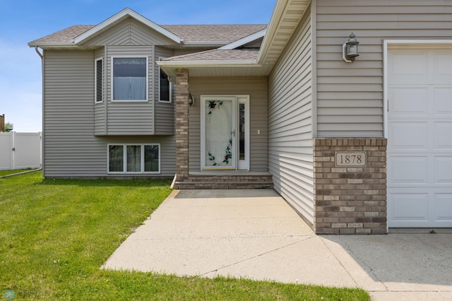 1878 10th St W, West Fargo, ND 58078 - view of exterior entry featuring a shingled roof and a garage