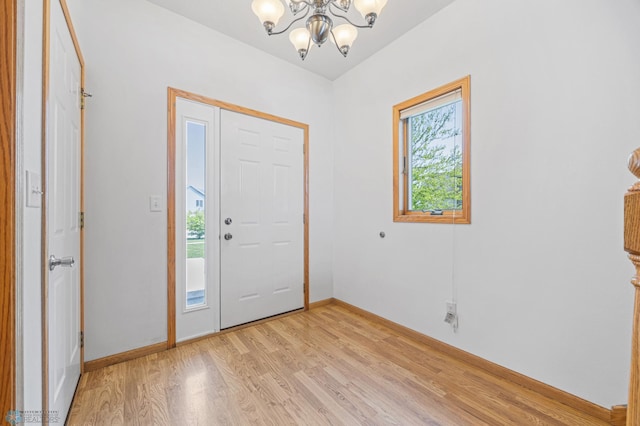 1878 10th St W, West Fargo, ND 58078 - foyer entrance with a chandelier, light wood-style floors, and baseboards
