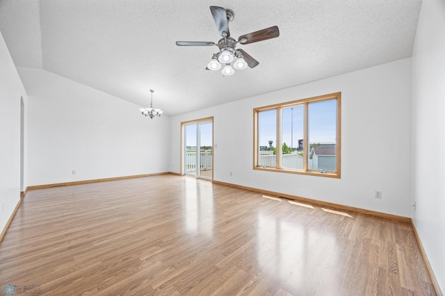 1878 10th St W, West Fargo, ND 58078 - empty room with a chandelier, ceiling fan, light wood-style flooring, a textured ceiling, and vaulted ceiling