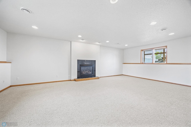 1878 10th St W, West Fargo, ND 58078 - basement featuring carpet floors, baseboards, a glass covered fireplace, and recessed lighting
