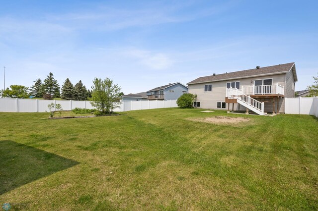 1878 10th St W, West Fargo, ND 58078 - view of yard featuring stairs, a deck, and a garden