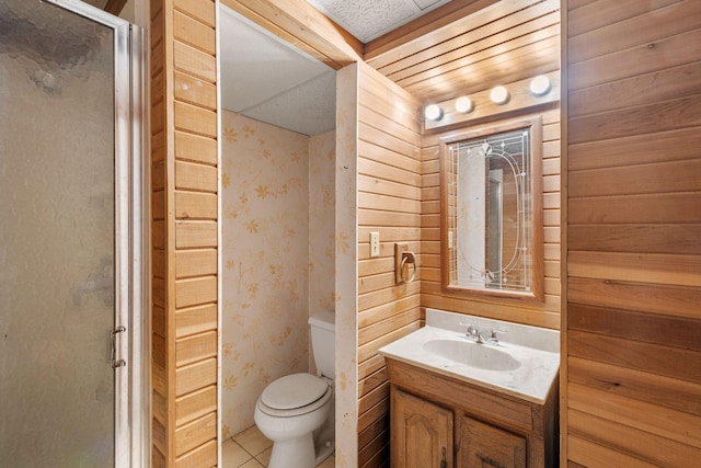 401 21st St SW, Austin, MN 55912 - full bathroom featuring vanity, toilet, a shower stall, tile patterned floors, and wooden walls