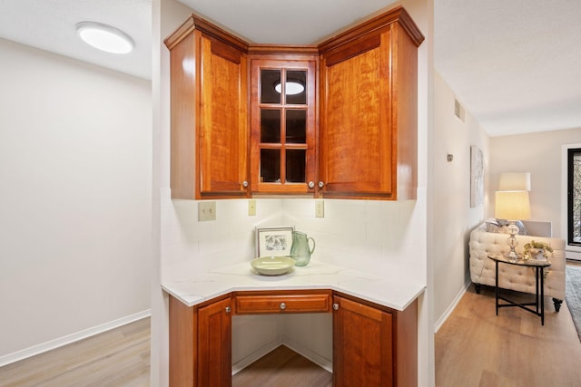 7510 Cahill Rd Unit 103B, Edina, MN 55439 - detailed view of wood finished floors, decorative backsplash, and baseboards