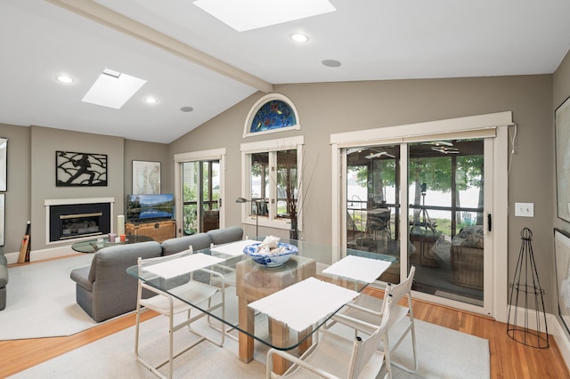 475 Lakeview Ave, Tonka Bay, MN 55331 - living area featuring a skylight, light wood-style floors, plenty of natural light, a glass covered fireplace, and recessed lighting
