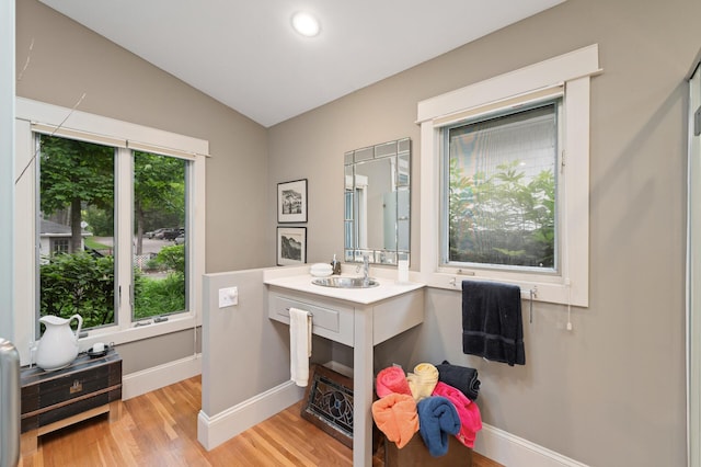 475 Lakeview Ave, Tonka Bay, MN 55331 - bathroom featuring wood finished floors, lofted ceiling, vanity, and recessed lighting