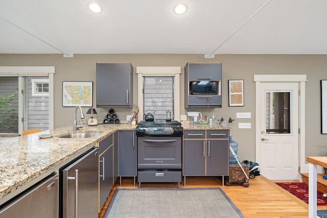 475 Lakeview Ave, Tonka Bay, MN 55331 - kitchen with stainless steel appliances, gray cabinets, wood finished floors, light stone counters, and recessed lighting