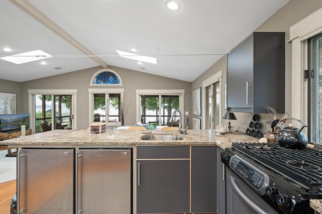 475 Lakeview Ave, Tonka Bay, MN 55331 - kitchen with a skylight, gas range, fridge, a peninsula, and recessed lighting