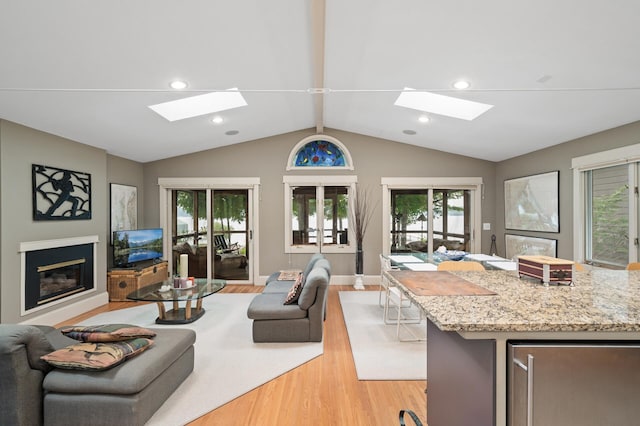 475 Lakeview Ave, Tonka Bay, MN 55331 - living area featuring a skylight, light wood-type flooring, recessed lighting, and a glass covered fireplace