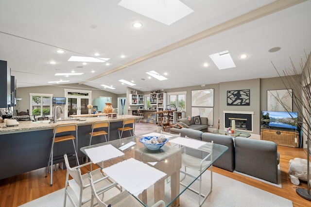 475 Lakeview Ave, Tonka Bay, MN 55331 - dining space with a skylight, light wood finished floors, lofted ceiling, and recessed lighting