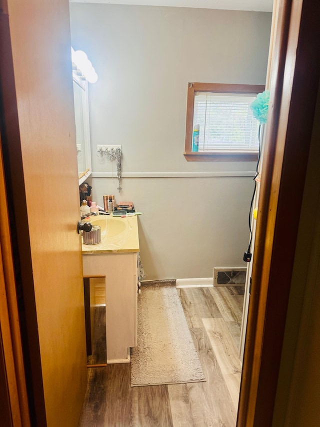 802 5th St NE, Little Falls, MN 56345 - bathroom featuring vanity and wood finished floors
