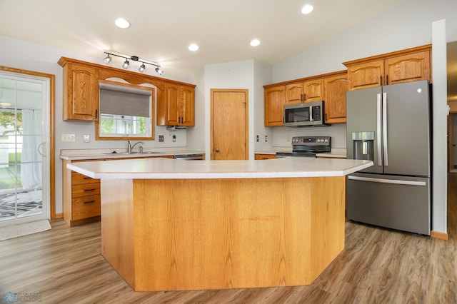 509 32nd St N, Moorhead, MN 56560 - kitchen featuring stainless steel appliances, a sink, light countertops, light wood-style flooring, and a center island