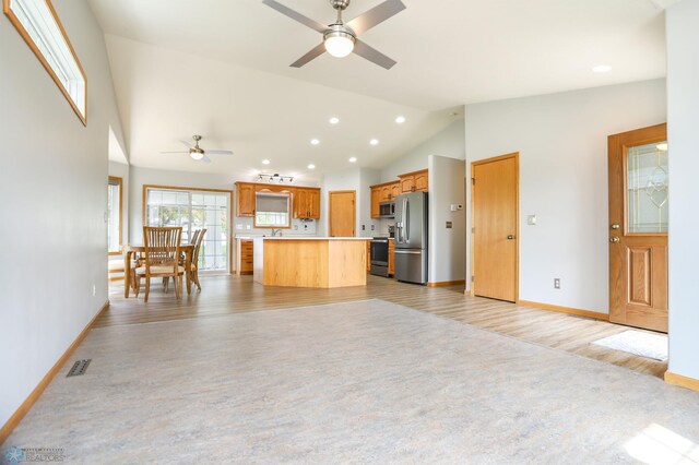 509 32nd St N, Moorhead, MN 56560 - kitchen featuring stainless steel appliances, ceiling fan, light wood finished floors, light countertops, and a kitchen island