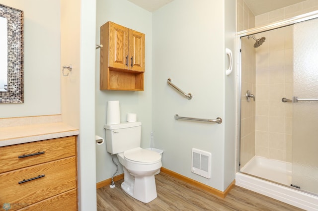 509 32nd St N, Moorhead, MN 56560 - full bath featuring wood finished floors, toilet, a stall shower, and vanity