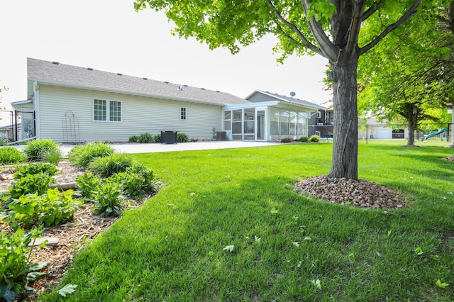 509 32nd St N, Moorhead, MN 56560 - rear view of property with a sunroom, a patio area, and cooling unit
