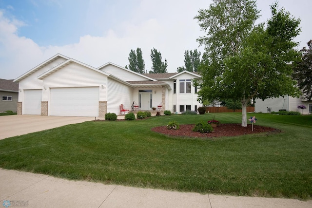1010 4th Ave NE, Dilworth, MN 56529 - split level home featuring a garage, a front yard, concrete driveway, and brick siding