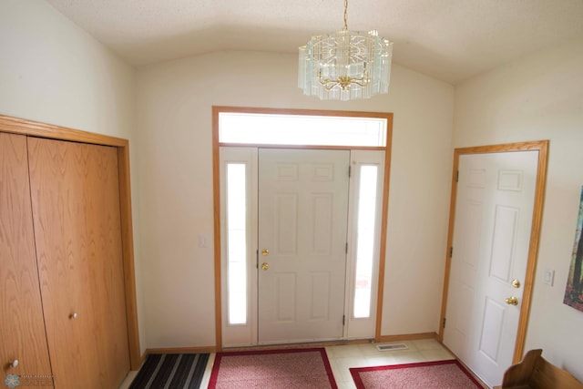 1010 4th Ave NE, Dilworth, MN 56529 - foyer with lofted ceiling, plenty of natural light, a chandelier, and baseboards