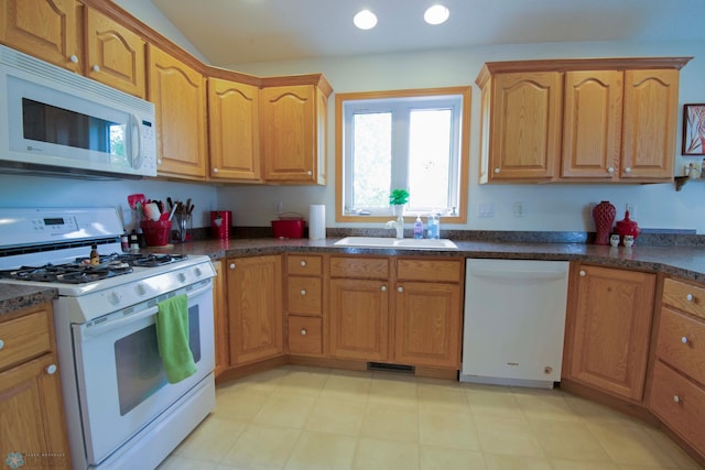 1010 4th Ave NE, Dilworth, MN 56529 - kitchen with white appliances, a sink, dark countertops, vaulted ceiling, and recessed lighting