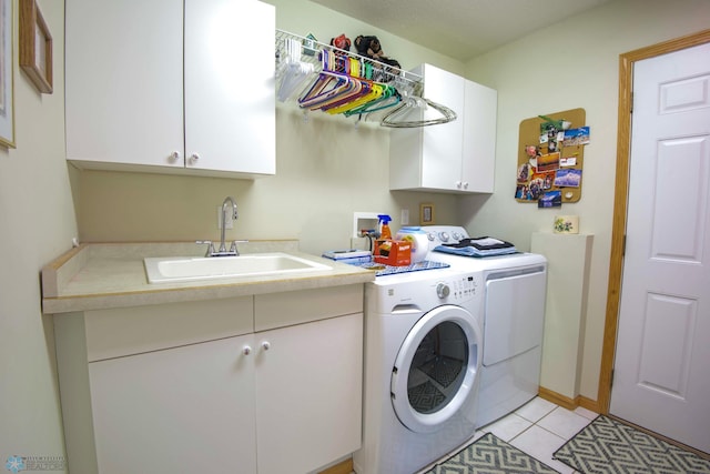 1010 4th Ave NE, Dilworth, MN 56529 - washroom with separate washer and dryer, cabinet space, and light tile patterned floors
