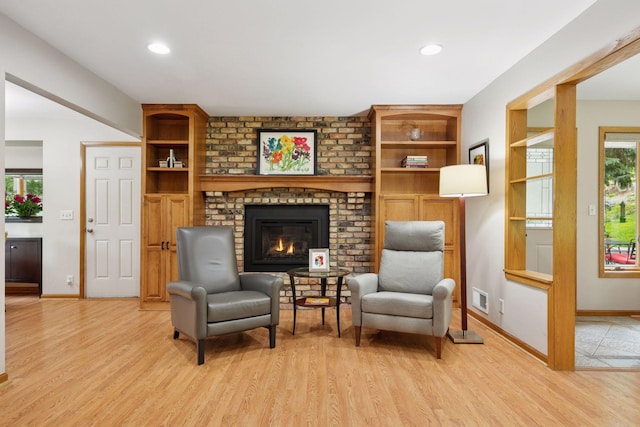 3933 Dartmouth Dr, Minnetonka, MN 55345 - sitting room with light wood-style floors, a brick fireplace, baseboards, and recessed lighting