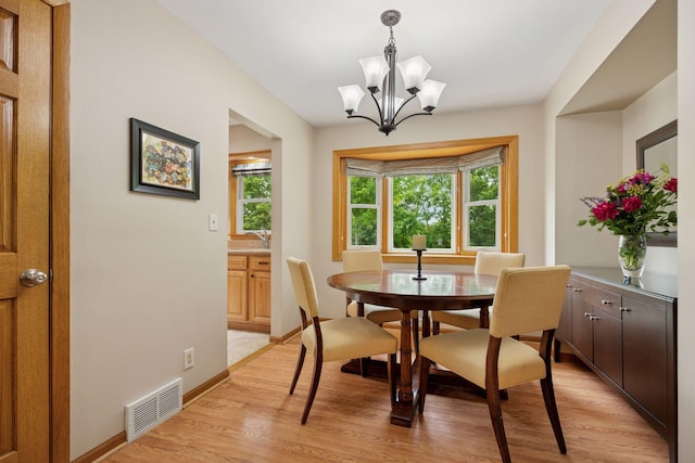 3933 Dartmouth Dr, Minnetonka, MN 55345 - dining space with light wood-style floors, a chandelier, and baseboards