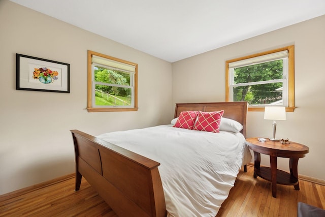 3933 Dartmouth Dr, Minnetonka, MN 55345 - bedroom featuring multiple windows, baseboards, and wood finished floors