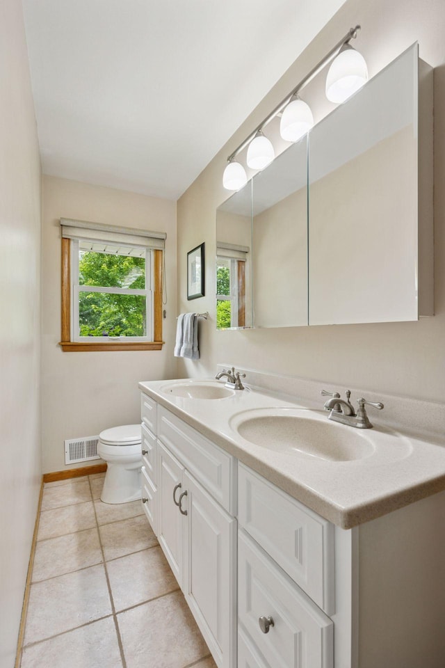 3933 Dartmouth Dr, Minnetonka, MN 55345 - full bathroom with toilet, double vanity, tile patterned floors, and baseboards