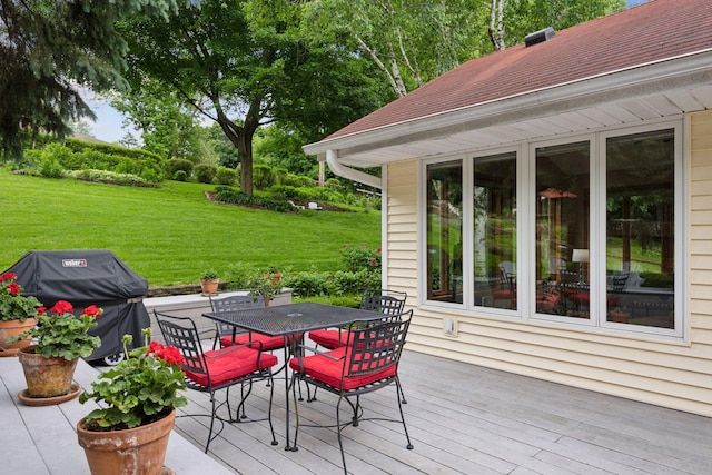 3933 Dartmouth Dr, Minnetonka, MN 55345 - wooden terrace featuring area for grilling, a lawn, and outdoor dining area