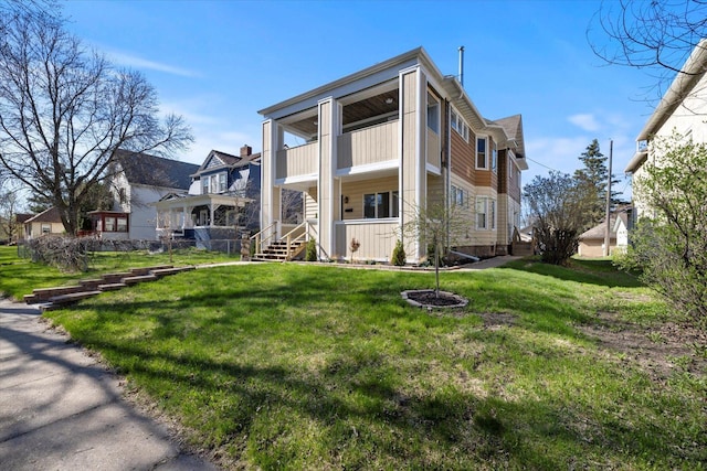 405 7th St S, Virginia, MN 55792 - rear view of house with a balcony, a yard, and board and batten siding