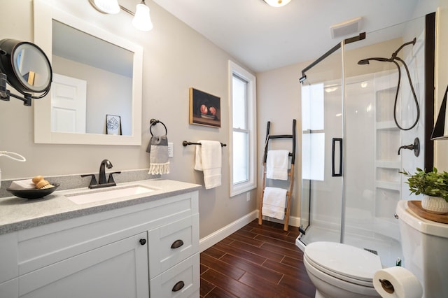405 7th St S, Virginia, MN 55792 - bathroom featuring toilet, a shower stall, baseboards, and vanity