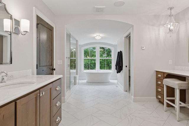 1432 25th St, Saint Joseph Twp, WI 54082 - full bath with vanity, a freestanding bath, baseboards, marble finish floors, and a chandelier