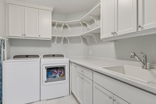 1432 25th St, Saint Joseph Twp, WI 54082 - laundry room featuring cabinet space, washing machine and dryer, and a textured ceiling