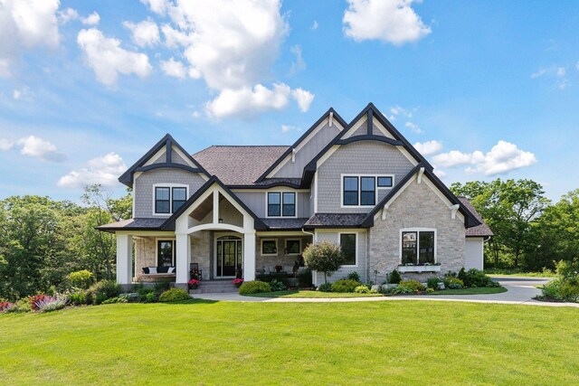 1432 25th St, Saint Joseph Twp, WI 54082 - craftsman house featuring stone siding, a front yard, a porch, and a shingled roof