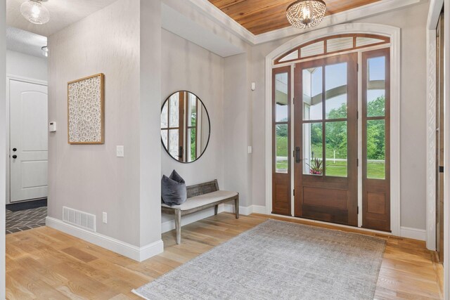 1432 25th St, Saint Joseph Twp, WI 54082 - entryway with baseboards, light wood finished floors, a chandelier, and ornamental molding