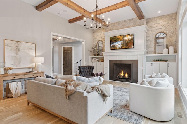1432 25th St, Saint Joseph Twp, WI 54082 - living area with beamed ceiling, light wood finished floors, a warm lit fireplace, stairs, and a chandelier
