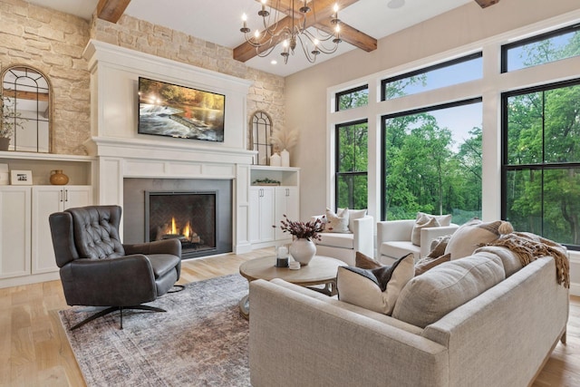 1432 25th St, Saint Joseph Twp, WI 54082 - living room featuring beamed ceiling, light wood finished floors, a large fireplace, and a chandelier