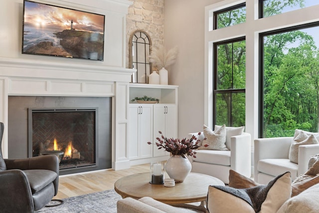 1432 25th St, Saint Joseph Twp, WI 54082 - living room featuring a lit fireplace and light wood-type flooring
