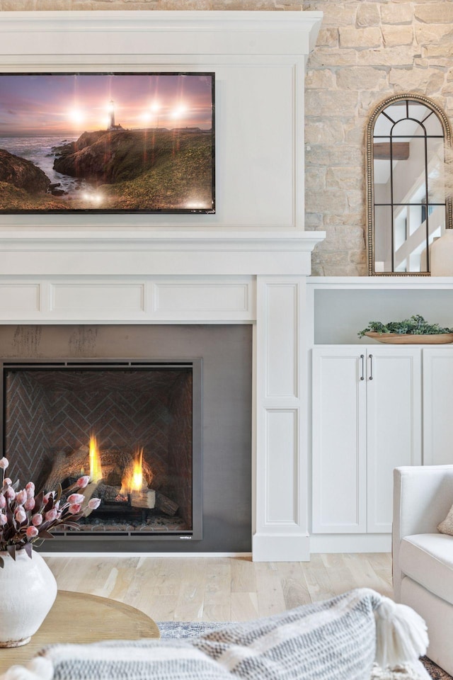 1432 25th St, Saint Joseph Twp, WI 54082 - detailed view of a lit fireplace and wood finished floors