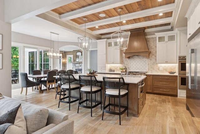1432 25th St, Saint Joseph Twp, WI 54082 - kitchen featuring a chandelier, open floor plan, appliances with stainless steel finishes, custom exhaust hood, and wooden ceiling with exposed beams