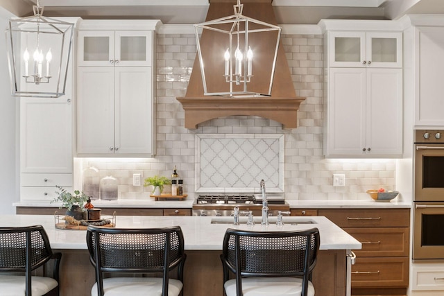 1432 25th St, Saint Joseph Twp, WI 54082 - kitchen featuring a chandelier, stainless steel double oven, and a kitchen bar