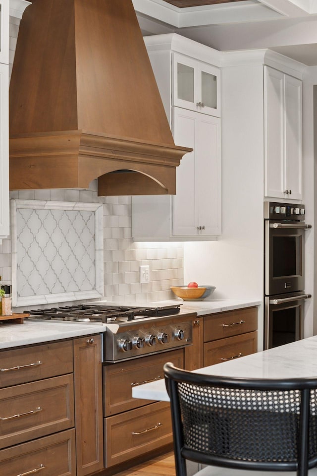 1432 25th St, Saint Joseph Twp, WI 54082 - kitchen with custom exhaust hood, stainless steel appliances, white cabinetry, and decorative backsplash