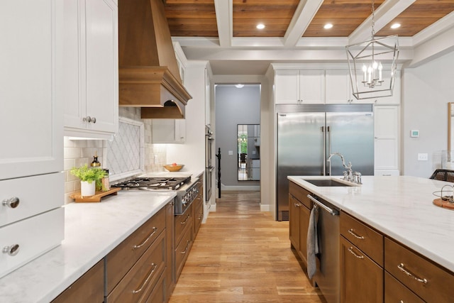 1432 25th St, Saint Joseph Twp, WI 54082 - kitchen featuring appliances with stainless steel finishes, a sink, recessed lighting, premium range hood, and light wood-style flooring