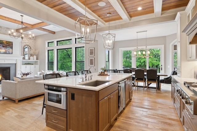 1432 25th St, Saint Joseph Twp, WI 54082 - kitchen with a sink, a chandelier, a breakfast bar, brown cabinets, and coffered ceiling