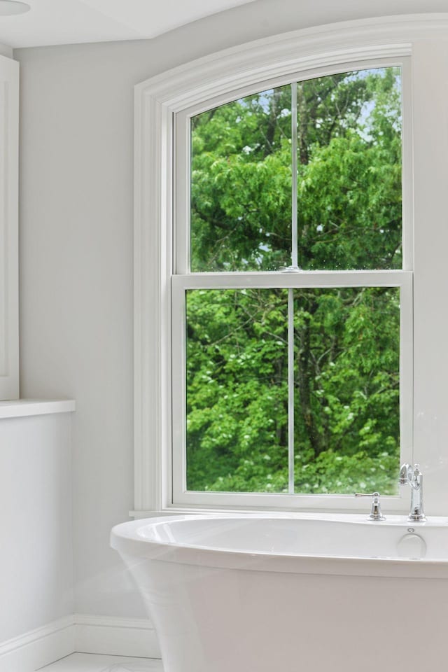 1432 25th St, Saint Joseph Twp, WI 54082 - bathroom featuring a freestanding bath and baseboards