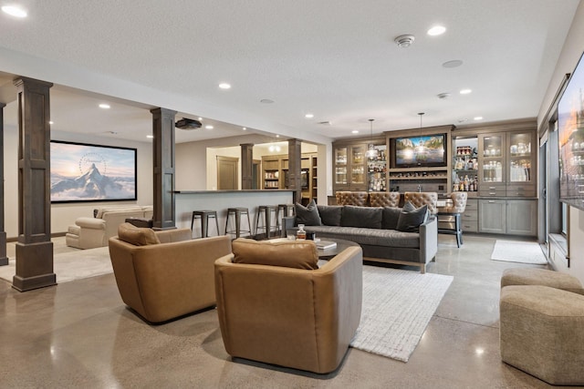 1432 25th St, Saint Joseph Twp, WI 54082 - living area with decorative columns, concrete flooring, recessed lighting, and bar area